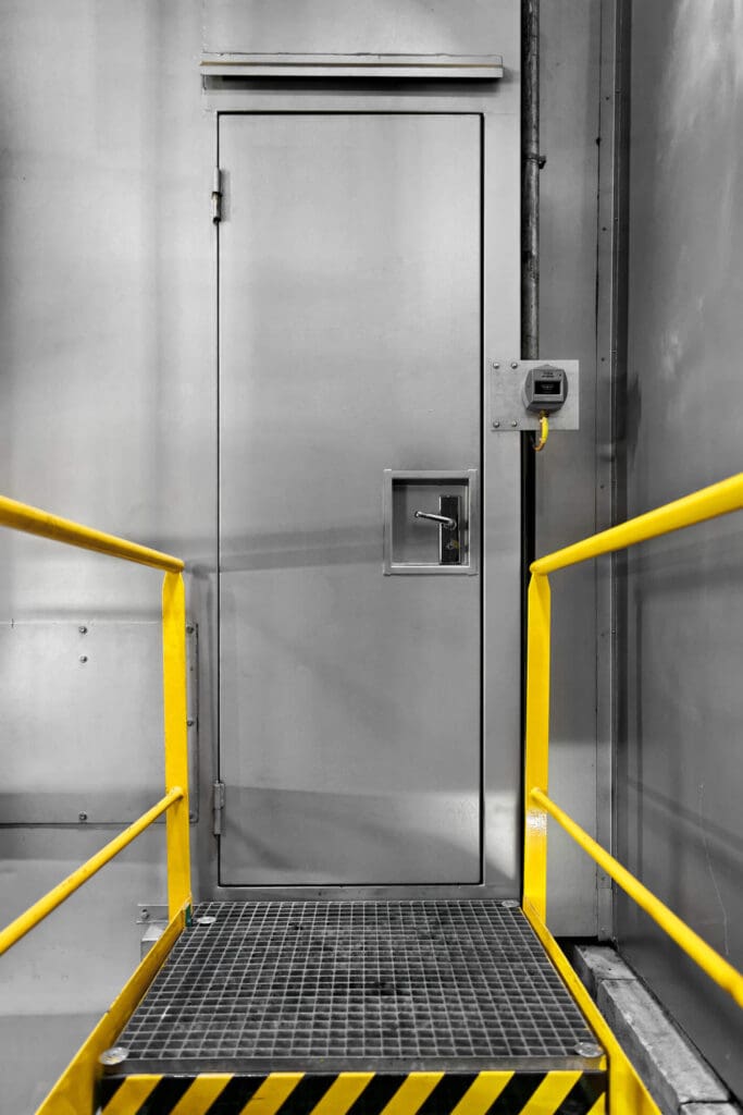 Steel industrial door with lock and yellow frame
